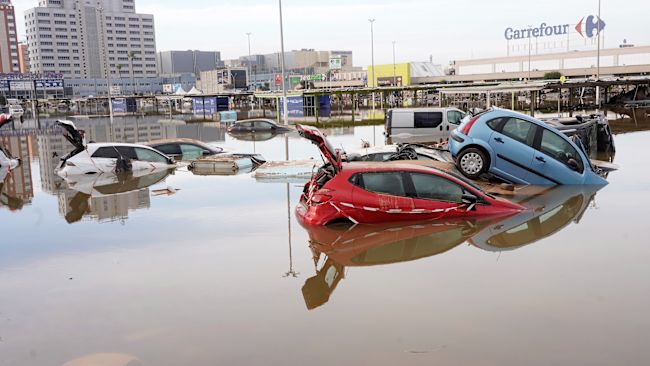 Cars are seen half submerged after floods in Valencia, Spain, Friday, Nov. 1, 2024.